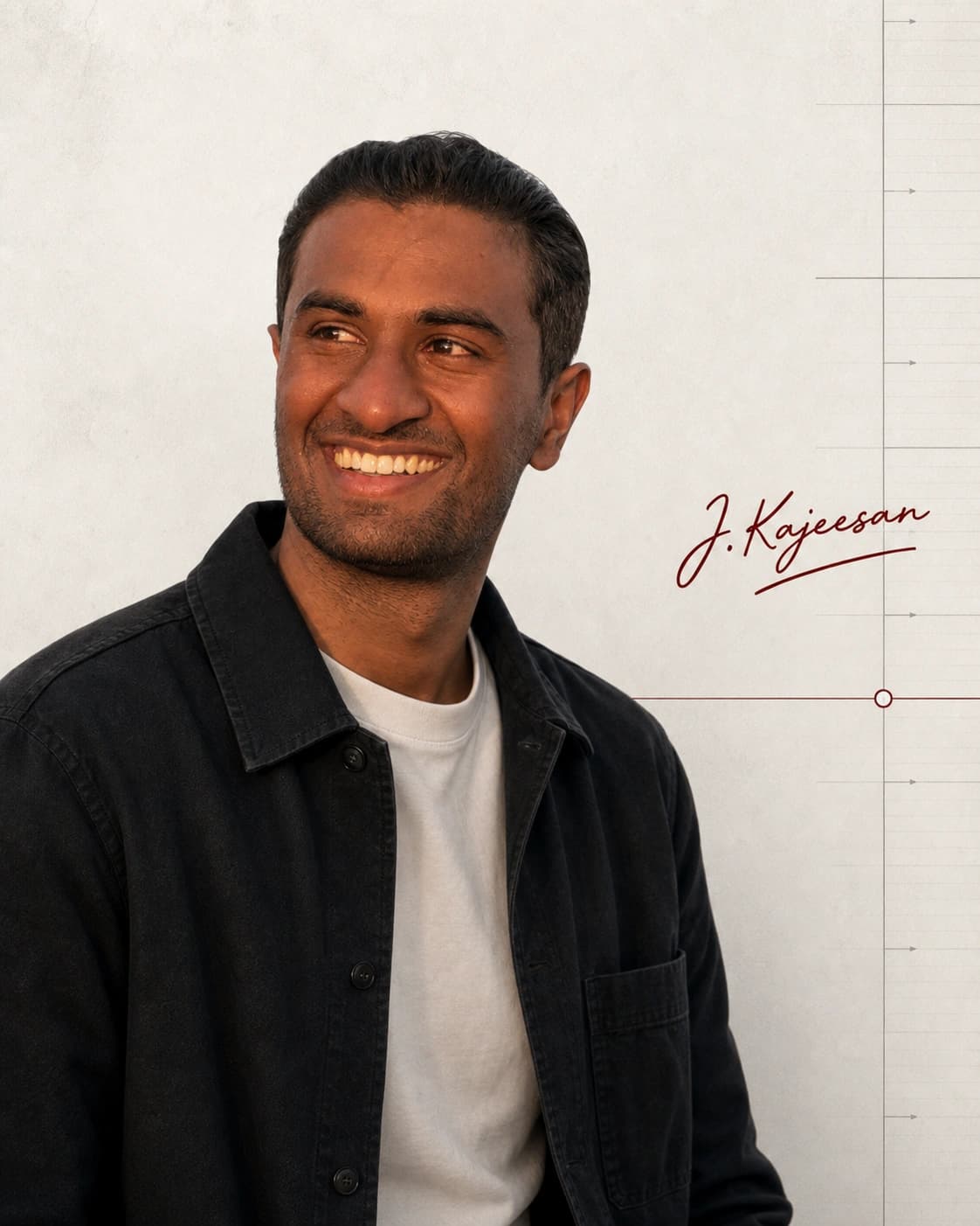 Kajeesan Jeevendra smiling and looking to the side, wearing a dark overshirt.