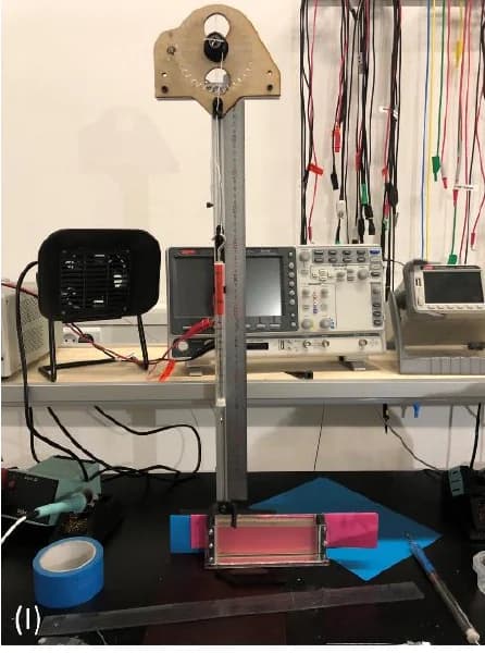Project photograph of the motorized vertical pull-test rig and specimen holder.